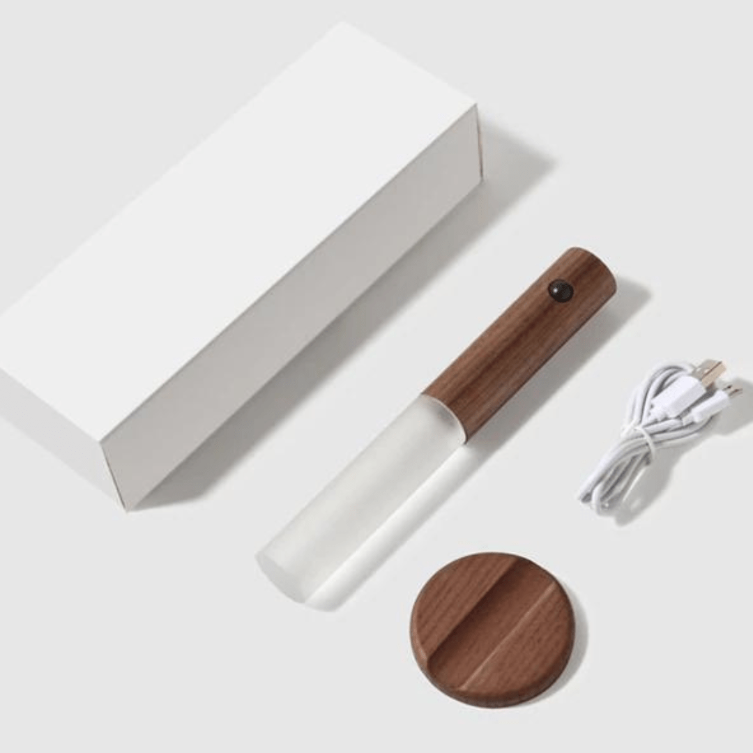 White and wooden device with a cable on a white background