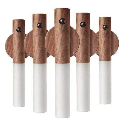 Set of five wooden wall hooks with white bases on a white background